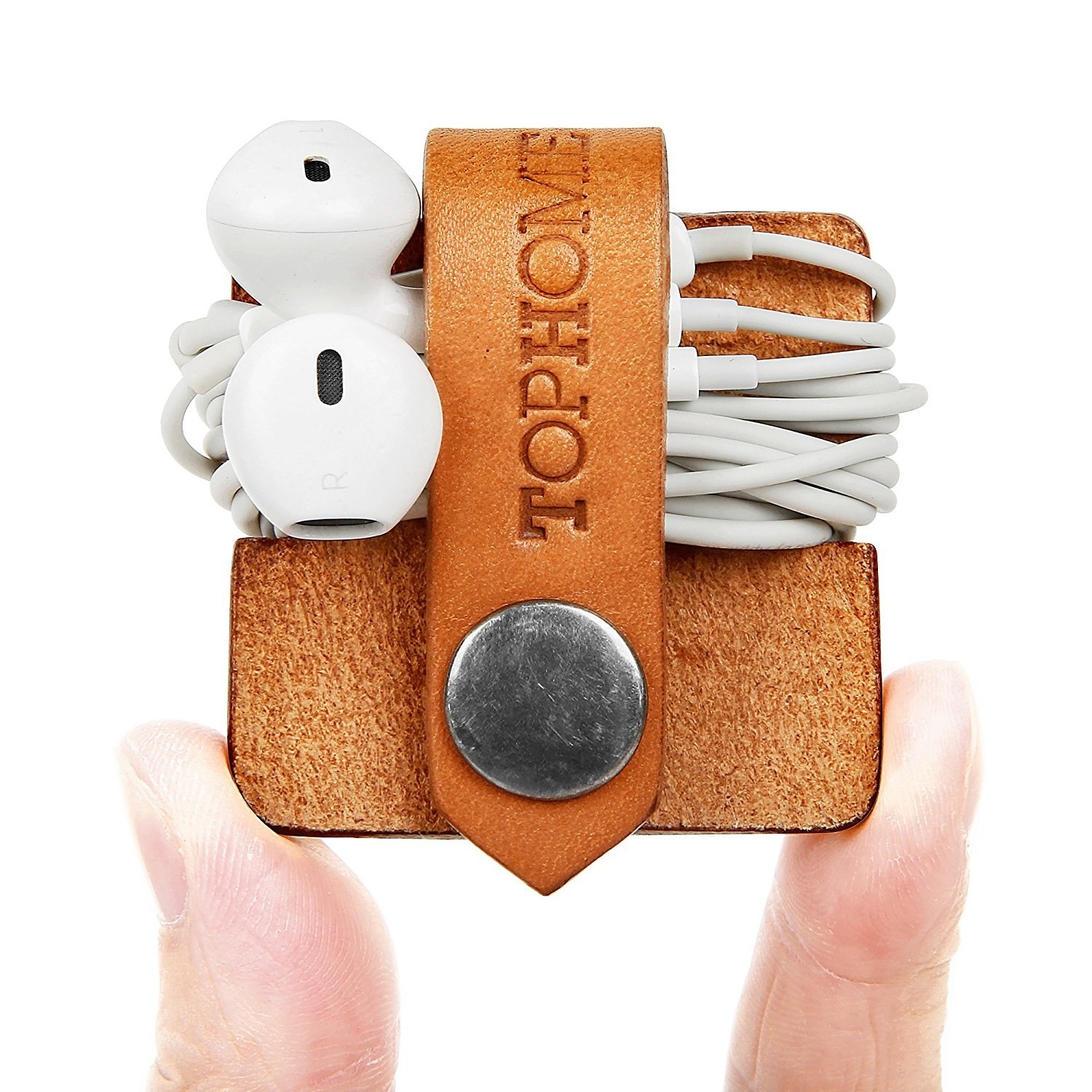 Hand holding the brown organizer with earbuds wrapped around it