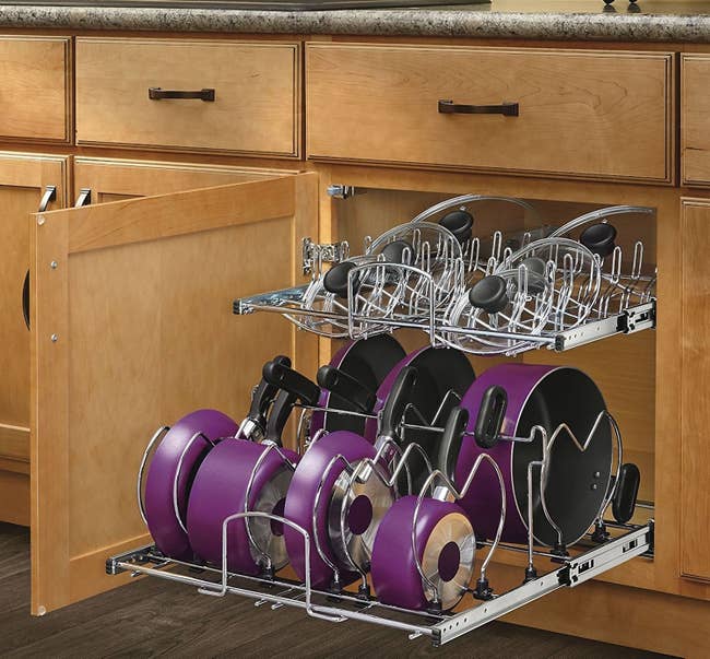 The metal organizer with seven pots/pans on the bottom and lids on top