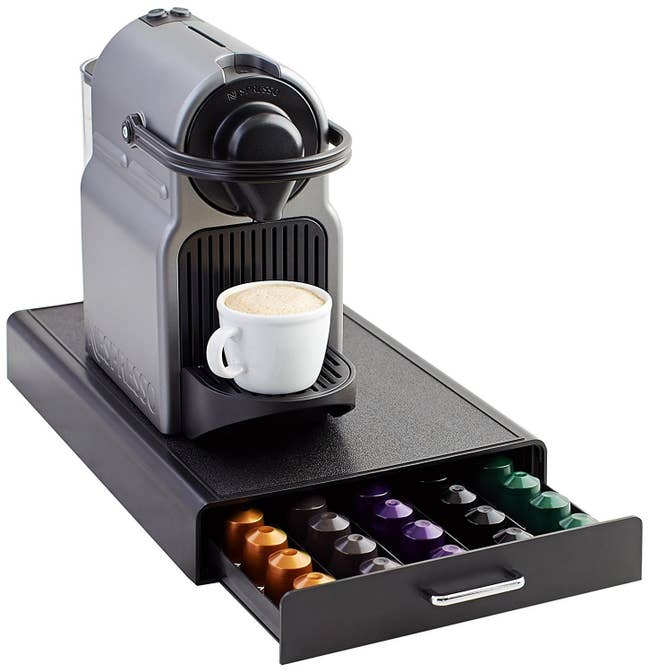 The drawer with capsules inside, with a Nespresso machine sitting on top