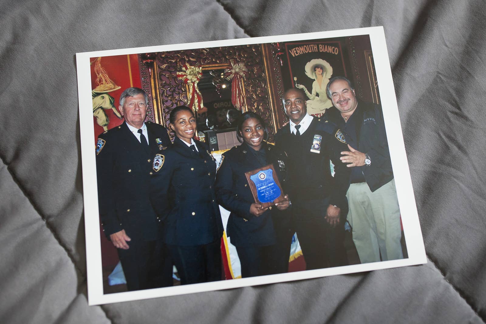 Inserillo (center) holds a plaque when she won officer of the month.