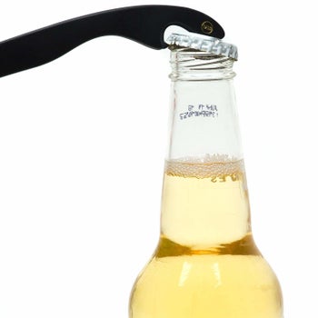 end of the sunglasses being used to open a longneck bottle of beer