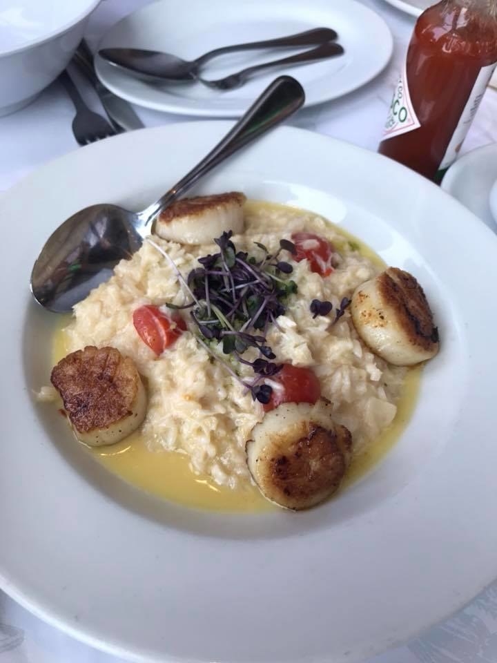 This seasonal special is an absolute must! The beautifully seared jumbo scallop is paired perfectly with creamy crab risotto, and topped with tomatoes, parmesan cheese, cilantro pesto, and beurre blanc sauce.
