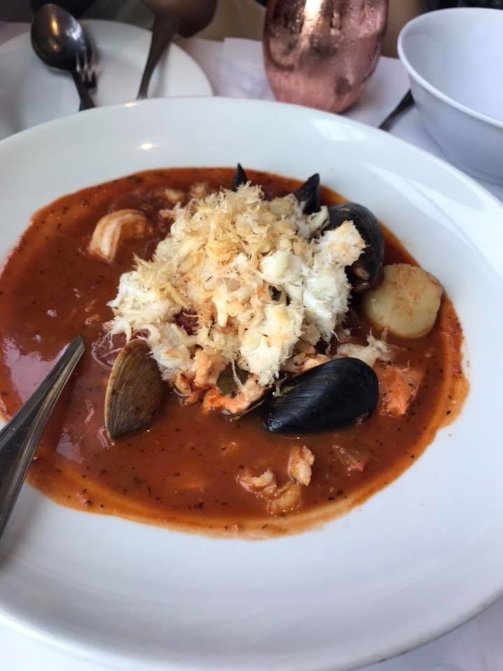 A San Francisco classic, the Cioppino includes generous serving of crab (if you opt in for the "lazy" cioppino, the crab meat is already shucked for you), fresh fish, shrimp, clams, scallops, and mussels, all stewed in a rich, hearty seafood tomato broth.