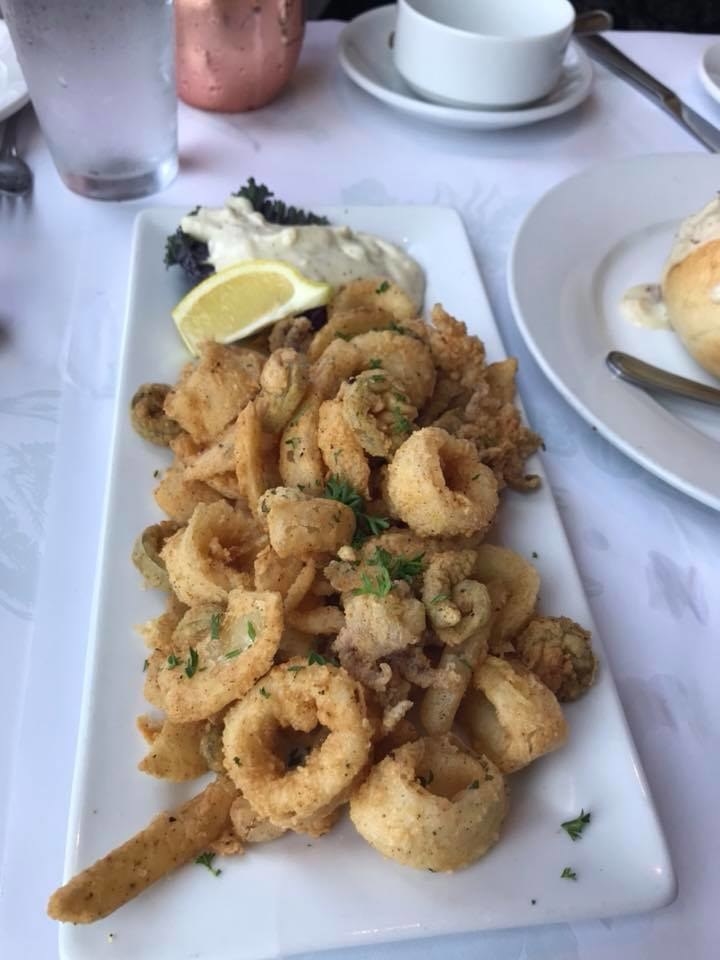 The platter of fried calamari has crispy edges, and also includes fried jalapenos and onions as well. The appetizer - perfect for sharing - is served with creamy lemon aioli.
