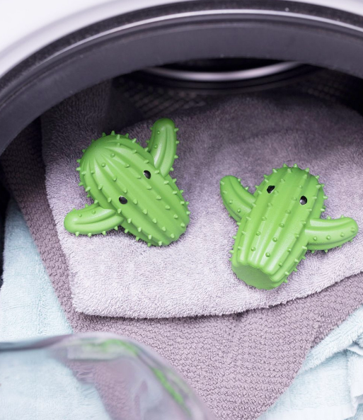 Two cacti-shaped dryer balls inside the laundry 
