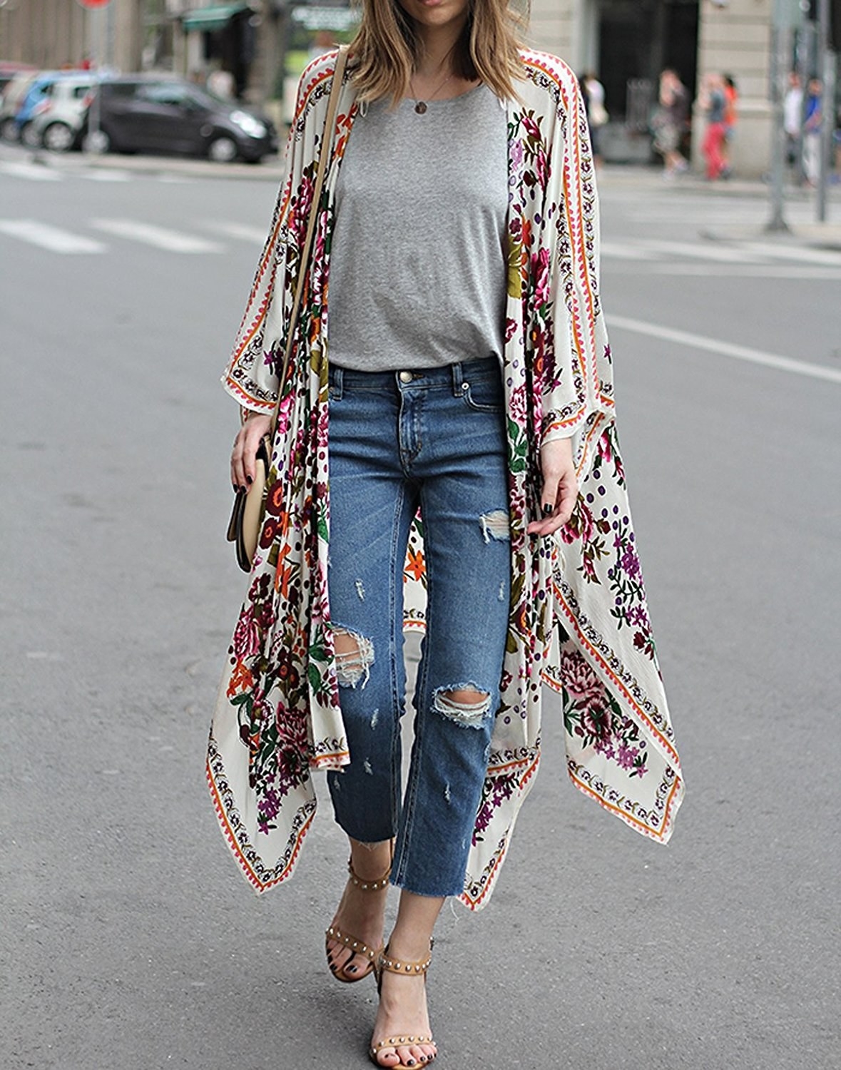 model wears floral cardigan over tee and jeans 