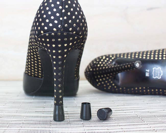 Photo of black studded high heels with high heel caps on them