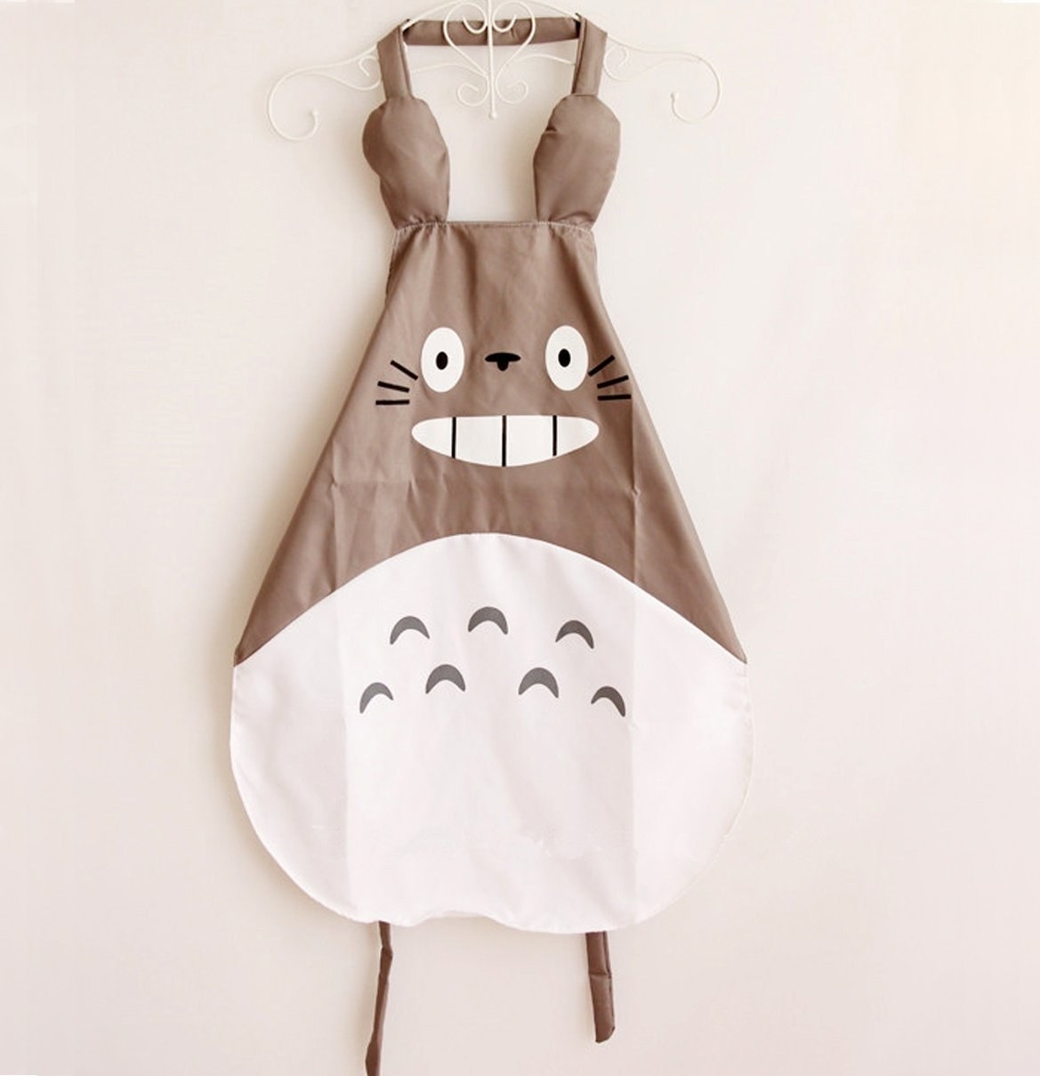 Promising review: "The apron is just as pictured and way adorable. It's made of some sort of vinyl like material, so it can repel water. Downside is that it runs kind of small. I bought this as a gift for a friend, and I'm worried it won't be able to fit her. Even on me (tall but wears an XXL in shirts), it just barely covered my torso." —m.huynh. Get it from Amazon for $8.96.