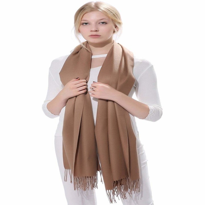 A model wearing the tan scarf around their neck