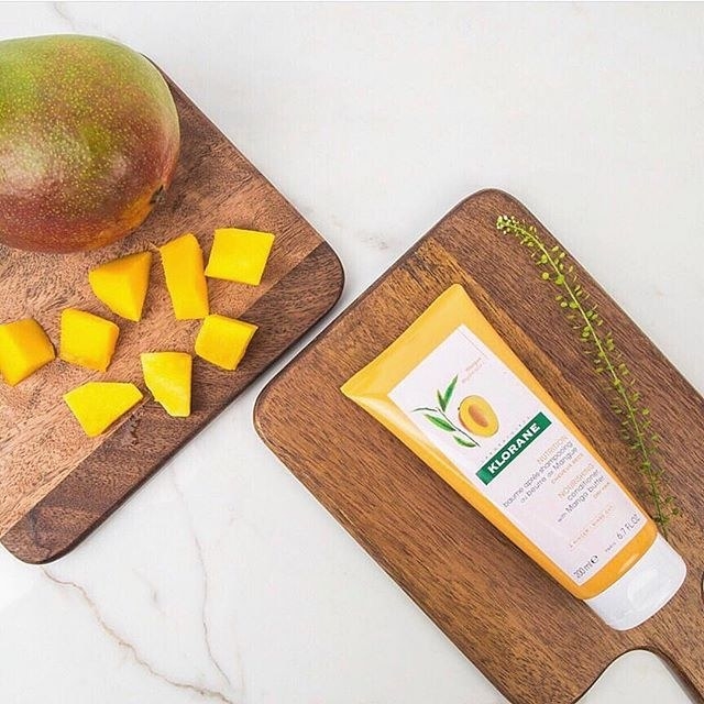 orange tube of hair product next to mango cubes