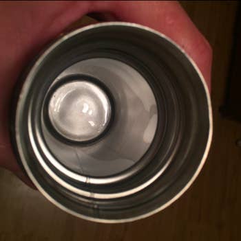 The same mug with the inside restored to a silver color, with the stains gone