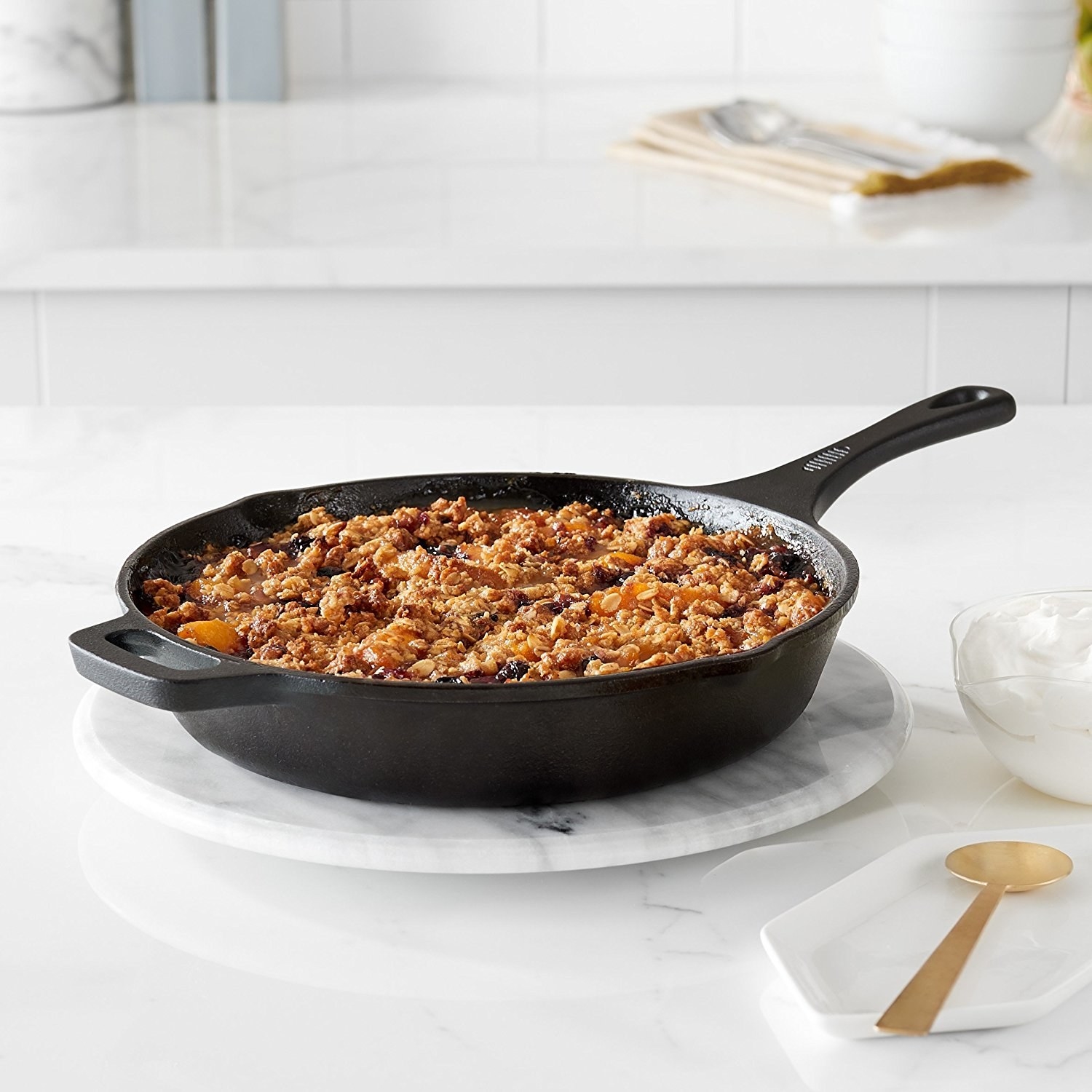 Product shot of a cast iron skillet filled with a casserole