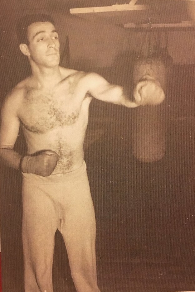 A man in an old photograph from years ago, boxing