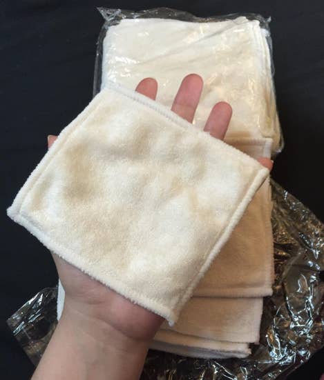 Reviewer holding hand-sized square of fabric cloth 