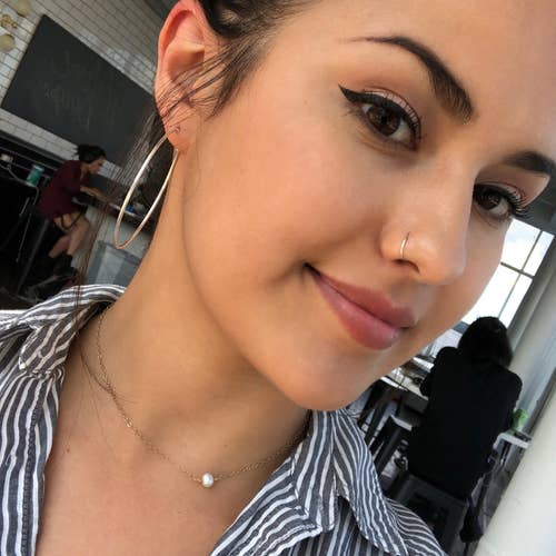 BuzzFeed editor Kayla Suazo with less circles under her eyes after using the concealer