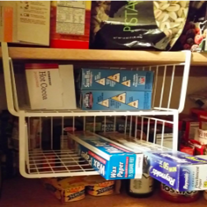 another reviewer's pic of two of the shelves hanging below a pantry shelf to hold items like aluminum foil in otherwise unused space