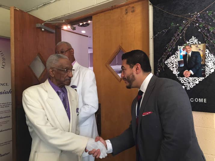 El-Sayed (right) greets members of a historically black church while campaigning in Detroit.