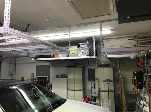 reviewer&#x27;s pic of garage with overhead heavy duty shelving units