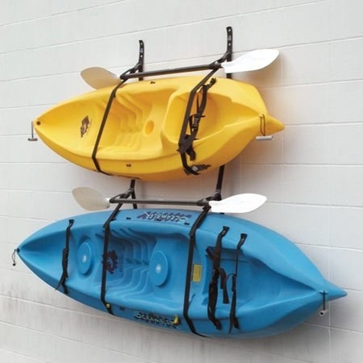 pic of two kayaks hung up on the wall with straps