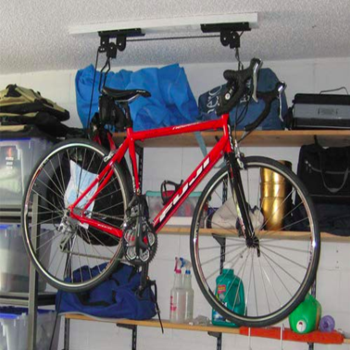 reviewer pic of bike hoisted up in a garage close to the ceiling and out of the way