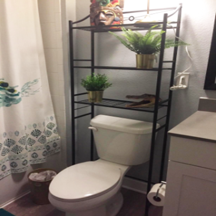 reviewer's bathroom with open shelving unit over the toilet