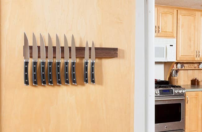 wood magnetic knife mount on a kitchen wall