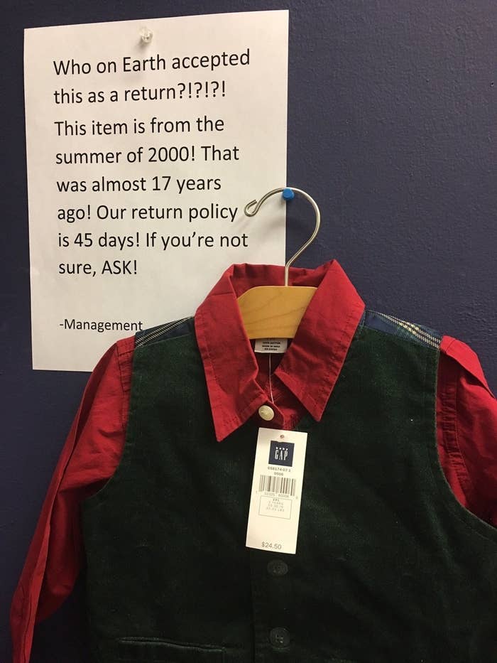 A shirt and vest with a $24.50 Gap label hangs with a sign next to it: &quot;Who on earth accepted this as a return?! This item is from the summer of 2000! That was 17 years ago! Our return policy is 45 days!&quot; —Management