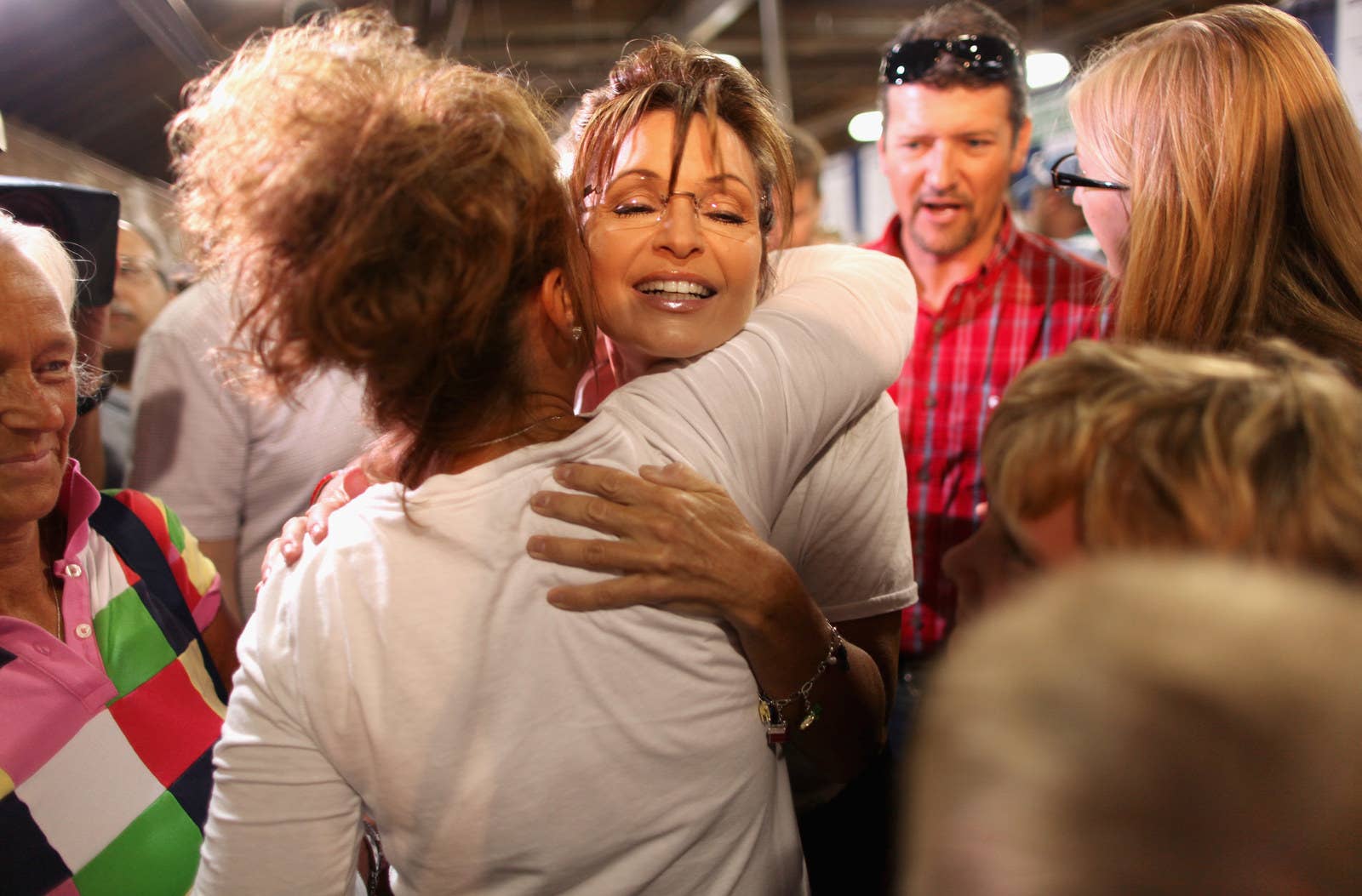 Former Alaska governor Sarah Palin embraces a fairgoer while visiting the Iowa State Fair on Aug. 12, 2011, in Des Moines.