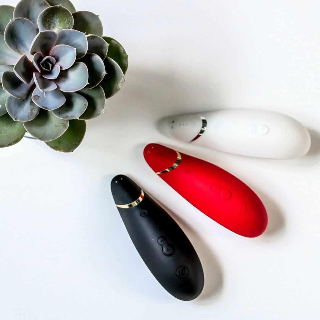 the Womanizer toys in black, red, and white