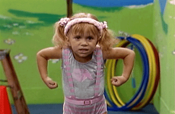 gif of Mary-Kate Olsen in the TV show &quot;Full House&quot; flexing her muscles and making a grrr face