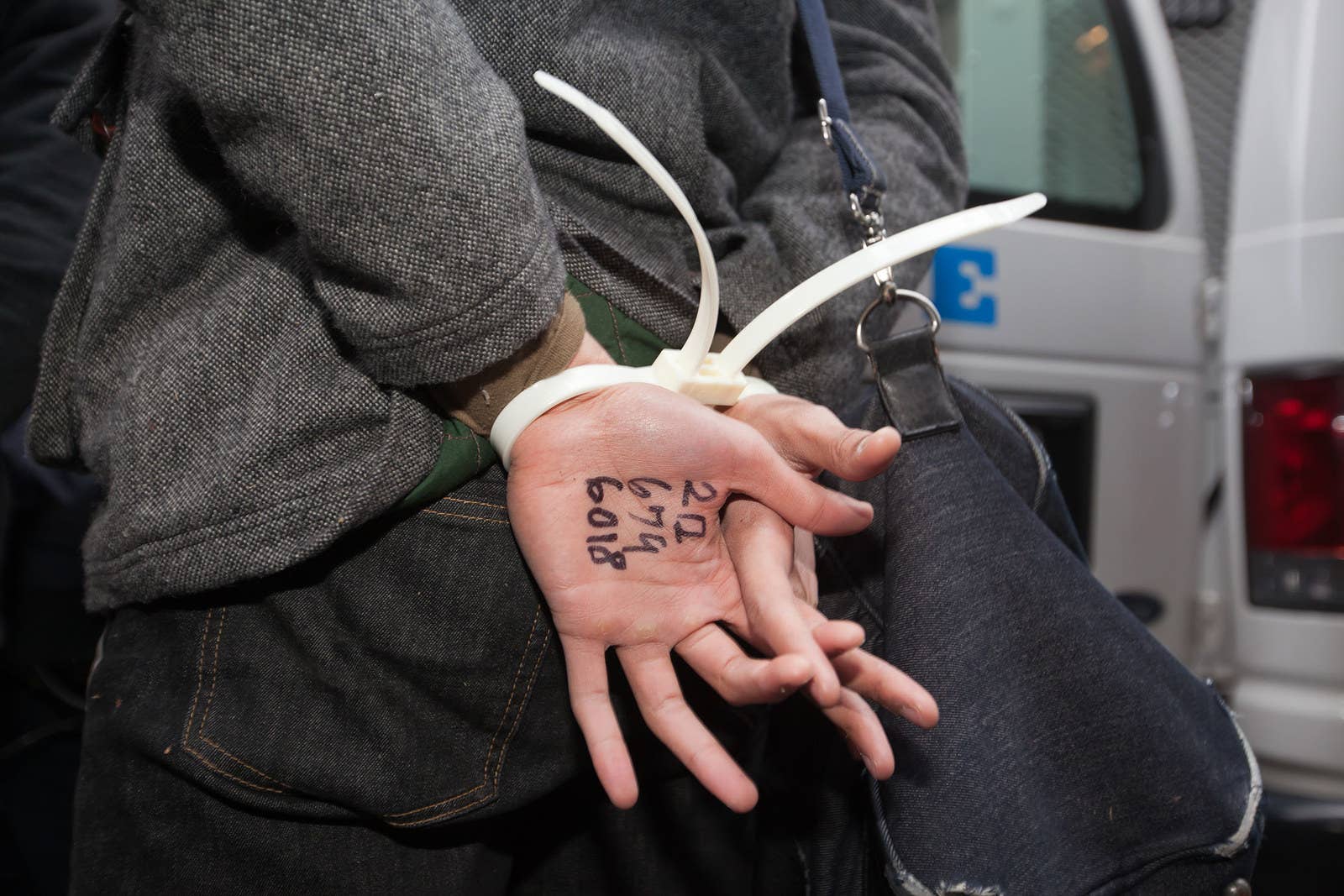 Police apprehend a protester with a lawyer&#x27;s phone number written on his hand on Nov. 17, 2011.