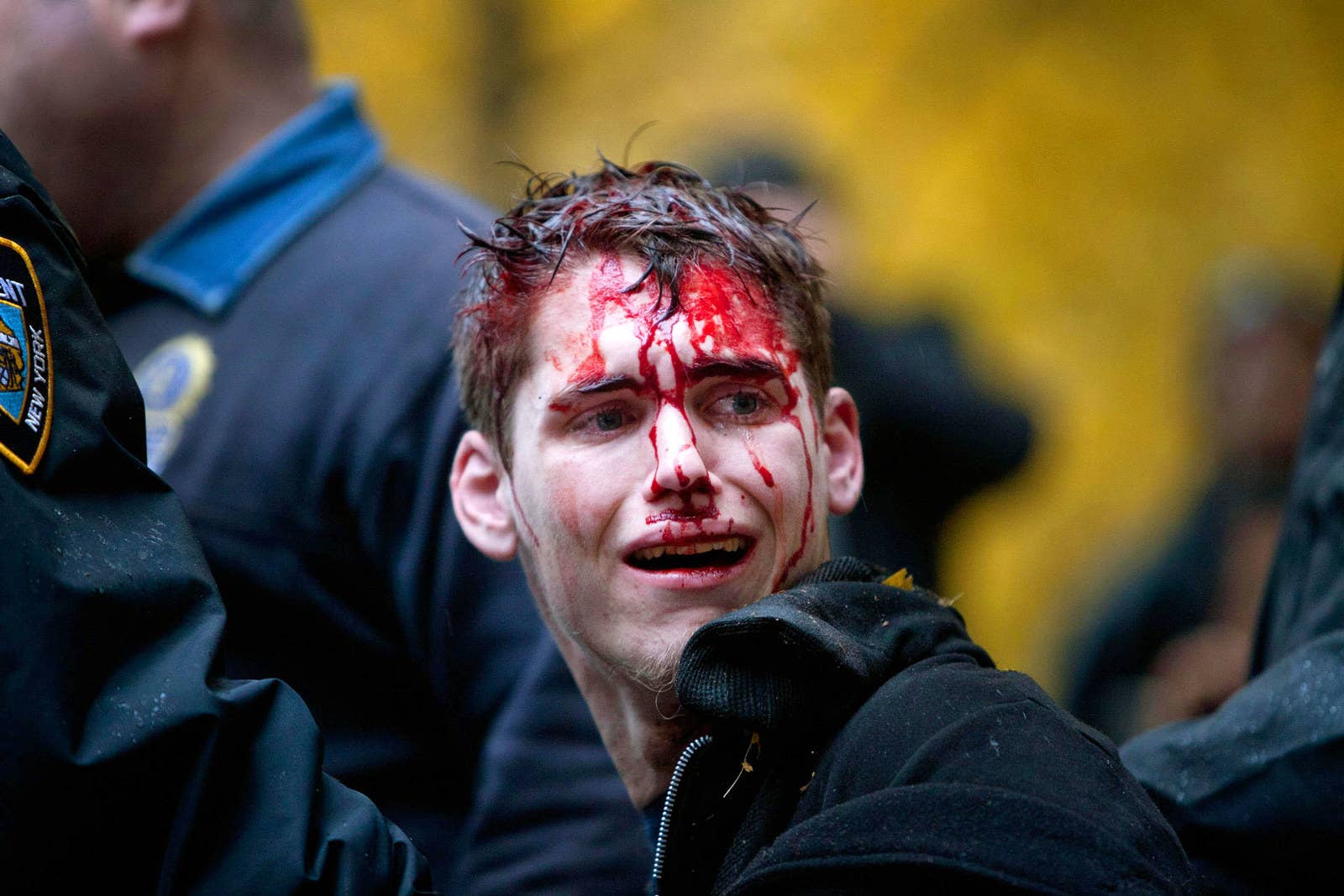 A man is seen with blood on his face after being apprehended by police in Zuccotti Park on Nov. 17, 2011.