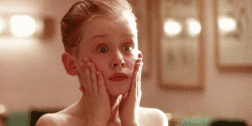 gif of Mullally Culkin in the movie &quot;Home Alone&quot; with his hands on his face screaming in shock