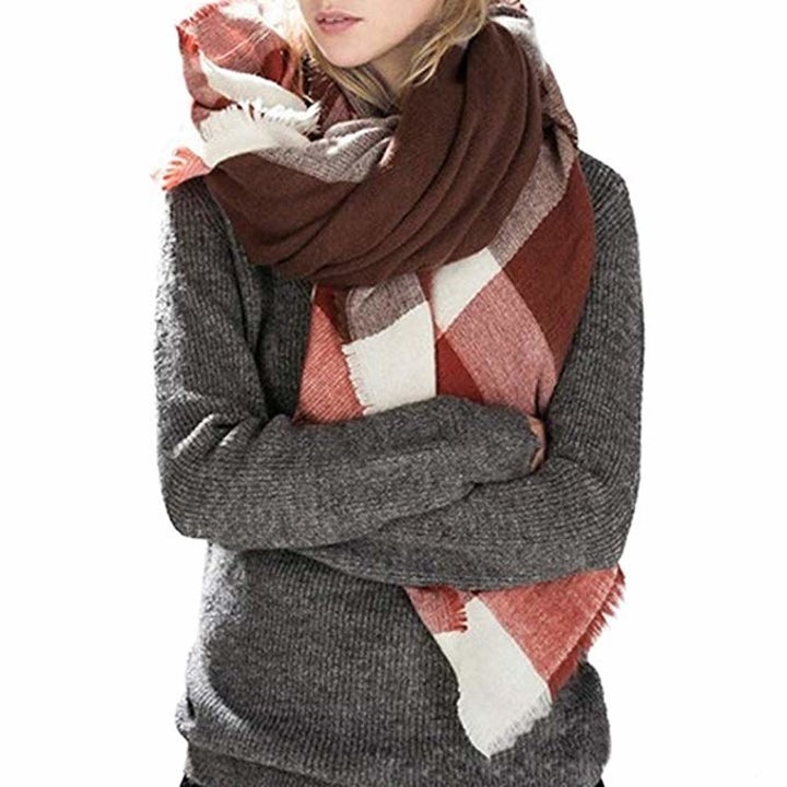 model wearing gray sweater and gray and red shawl style pashmina scarf