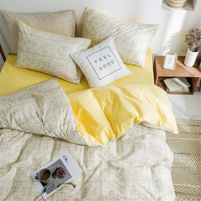 the yellow and beige duvet set with a pillow that reads feel good