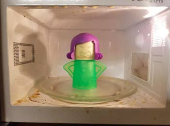 reviewer photo of the cleaner in a dirty microwave