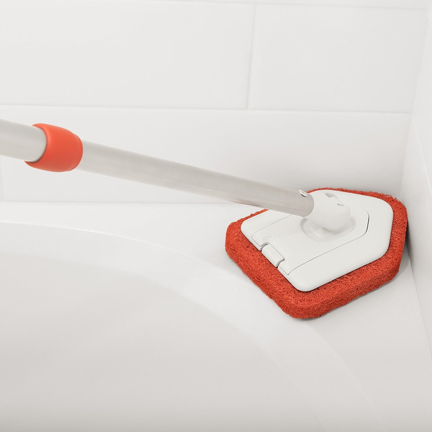 scrubber being used in bathtub corner