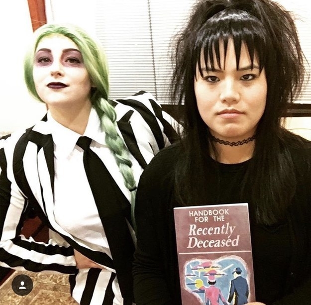 Someone dressed as Beetlejuice and another dressed as Lydia, holding the death pamphlet