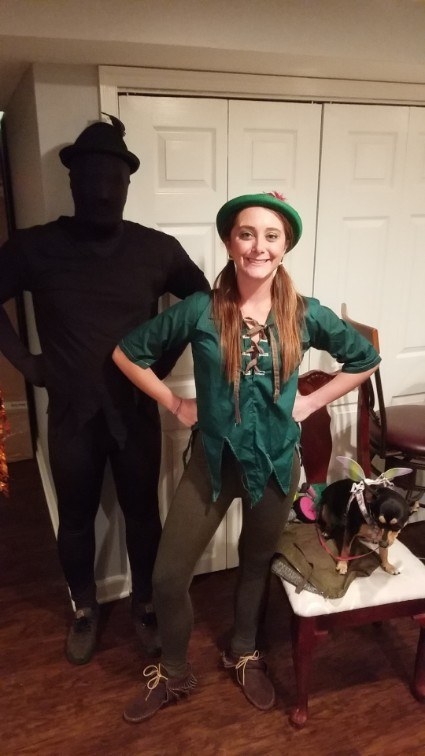 Someone dressed as Peter Pan, and another wearing all black dressed as its shadow
