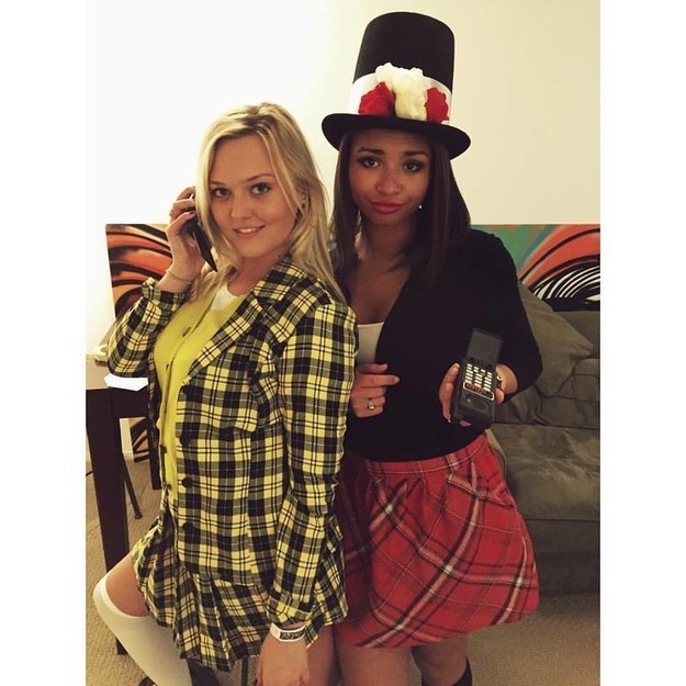 Two people dressed in the iconic Cher and Dionne yellow/red plaid outfits