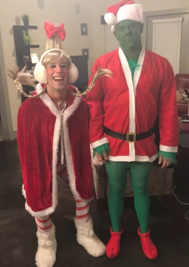 Someone dressed as The Grinch in a Santa costume and someone dressed as Cindy Lou Who