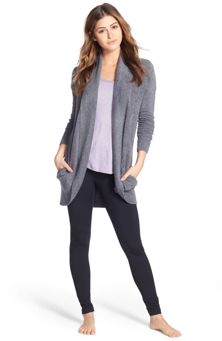A model wearing the cardigan in Pacific Blue with leggings