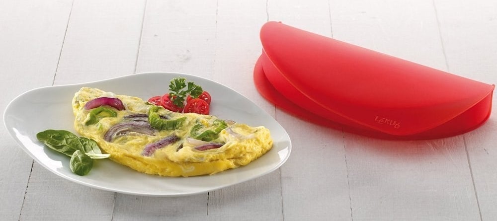 a veggie omelette on a plate near a microwave omelette maker