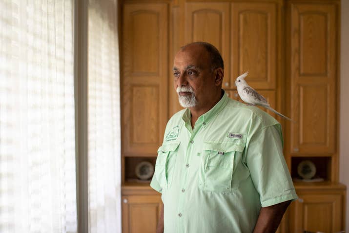 Khalifa with his cockatiel Snow at his home in Tyler, Texas.