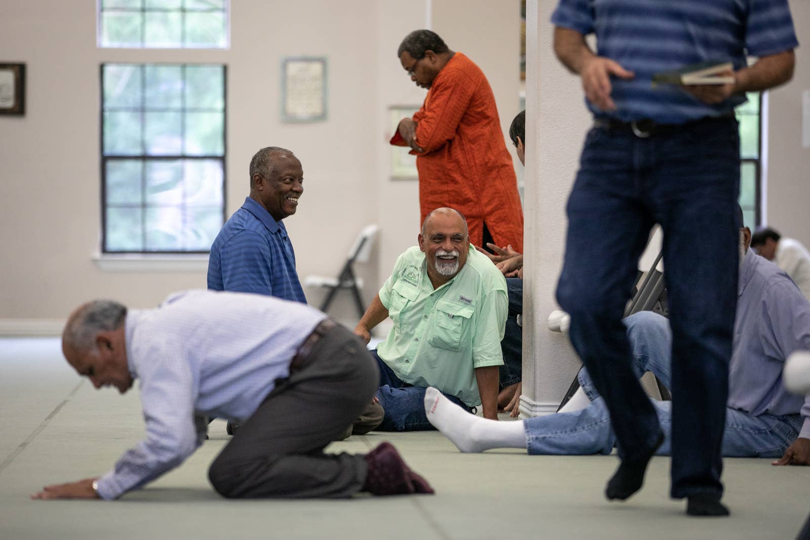 Khalifa chats with friends before Friday prayer at the East Texas Islamic Society in Tyler.