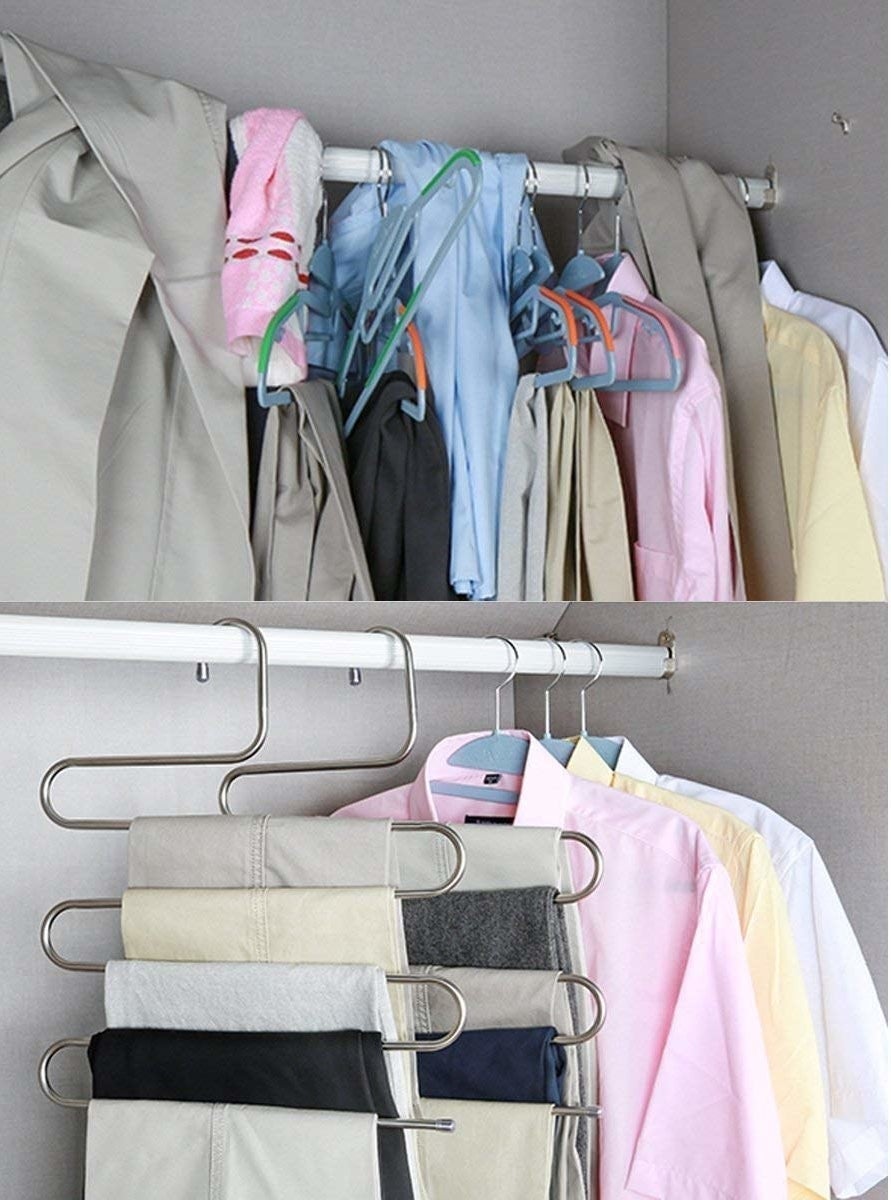 A curved S-shaped hanger holding five pairs of pants on different tiers