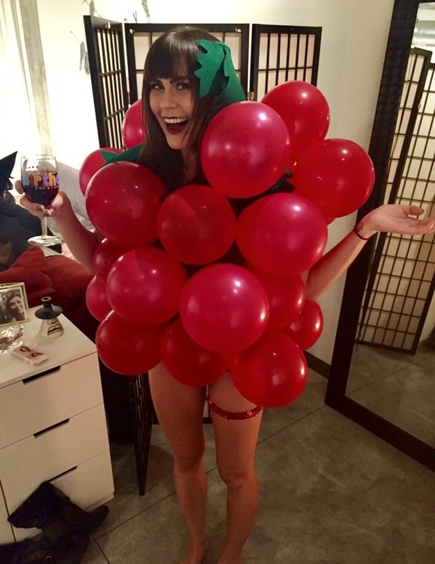 girl covered in red balloons