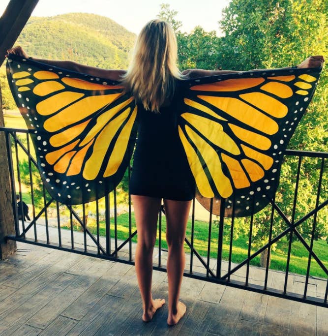reviewer wearing large orange butterfly wings 