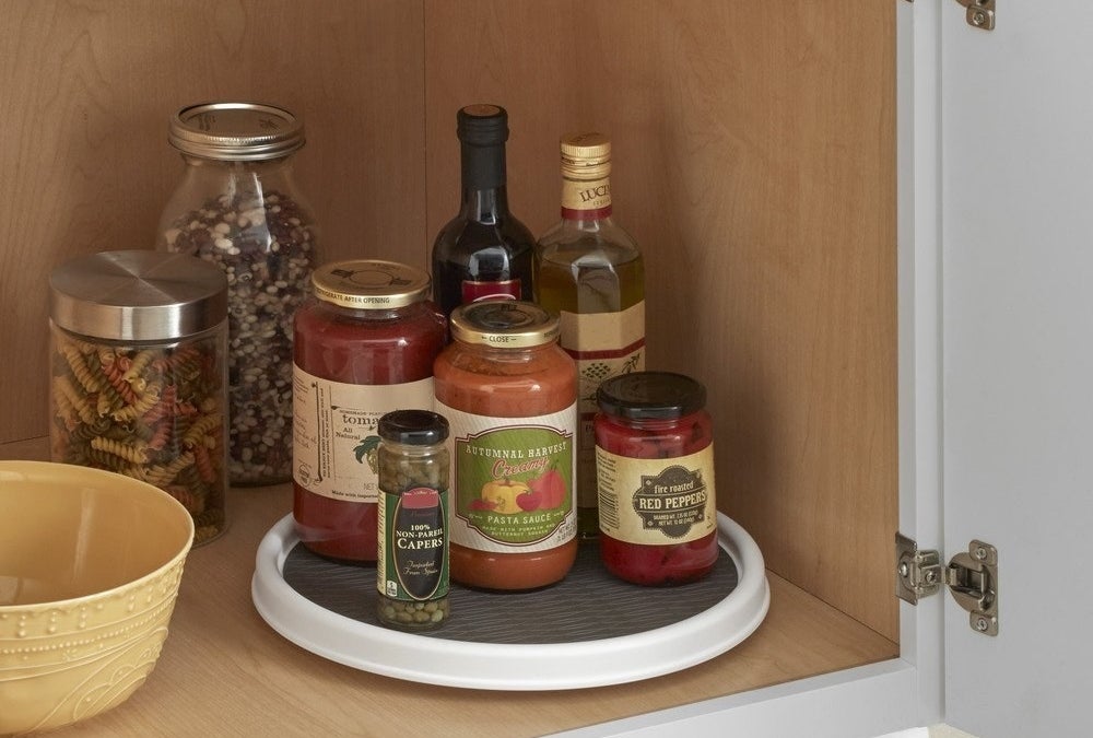 Sauces and wine placed on lazy susan in cabinet 