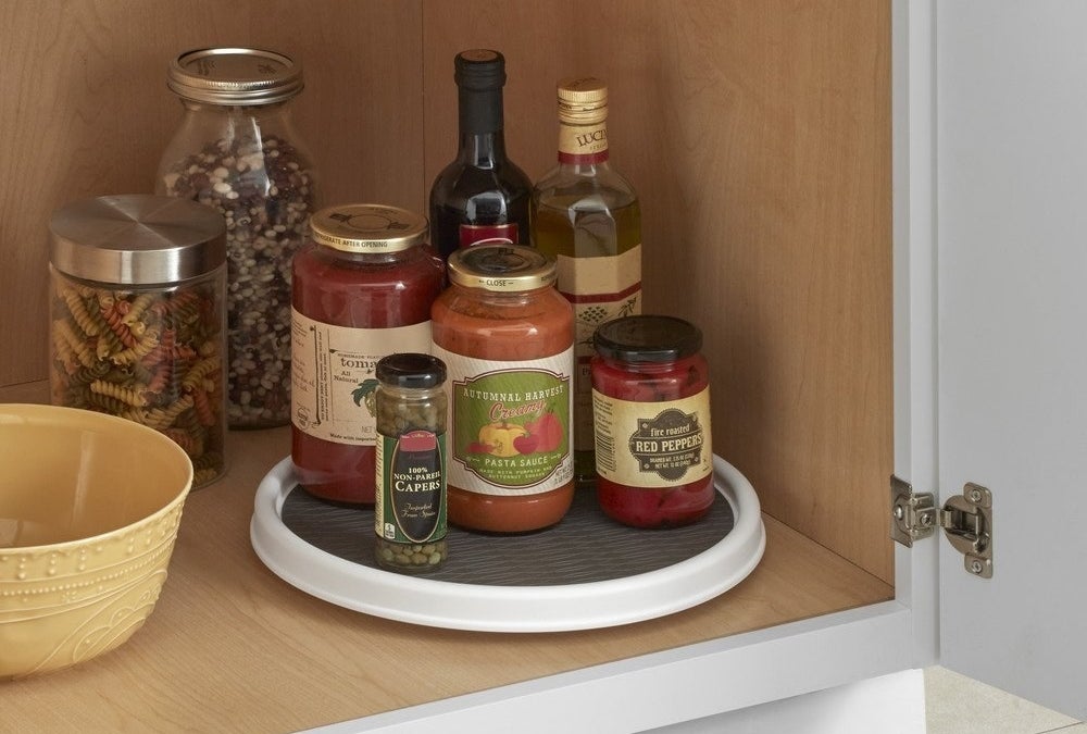Sauces and wine placed on lazy susan in cabinet 